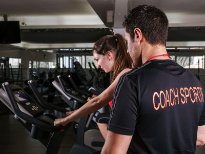 Young woman doing a workout with a sports coach Young woman doing a workout with a sports coach